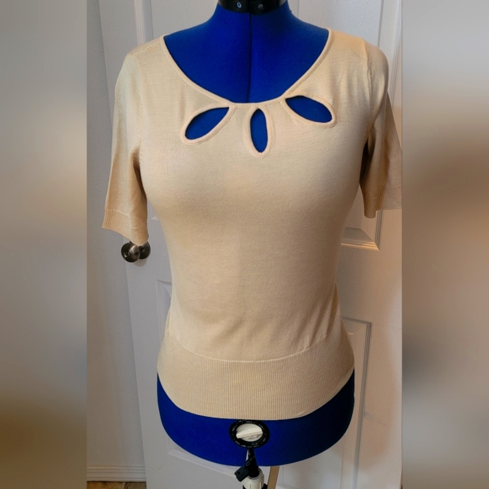 Short sleeve sweater with key holes in front.